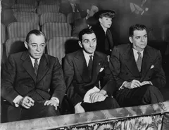 Songwriters Richard Rodgers, Irving Berlin and Oscar Hammerstein II in Broadway theatre seats, with choreographer Helen Tamiris behind